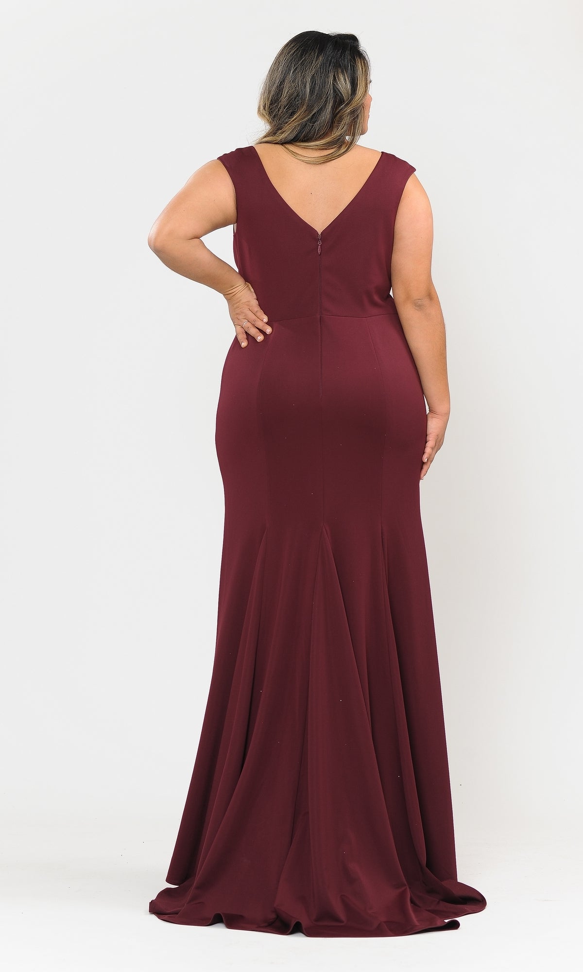 A person stands facing away, modeling the Classic Sleeveless Plus-Size Long Prom Dress W1022—a floor-length burgundy gown with a V-shaped back and slight train—against a plain white background.